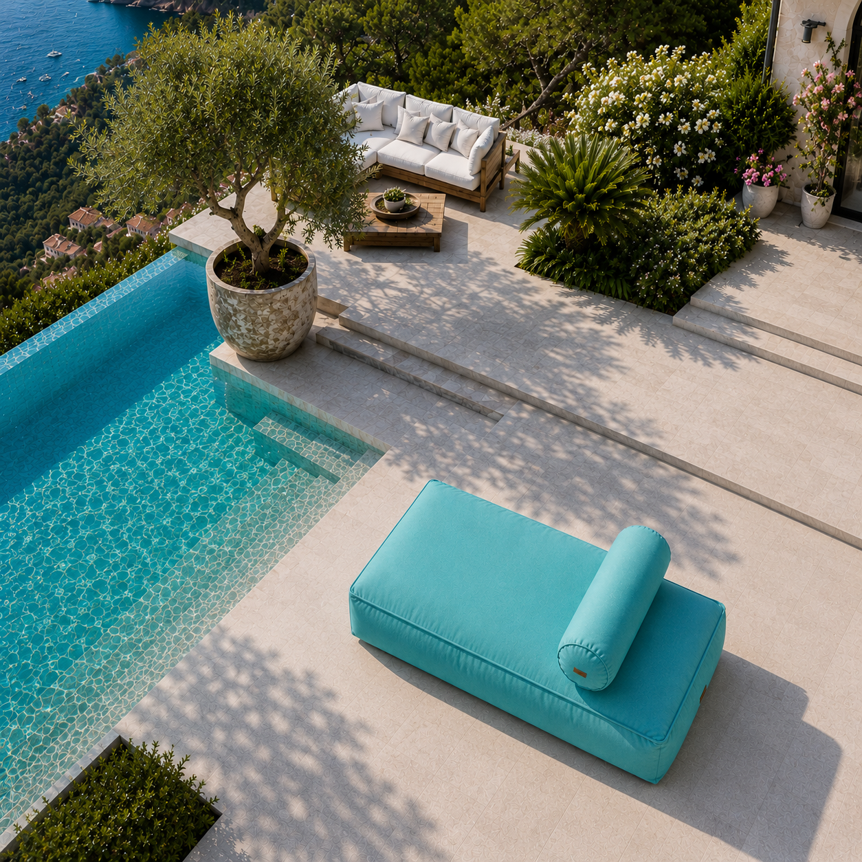 chillisy® Daybed in Türkis mit Nackenrolle auf luxuriöser Poolterrasse mit Meerblick aus der Vogelperspektive