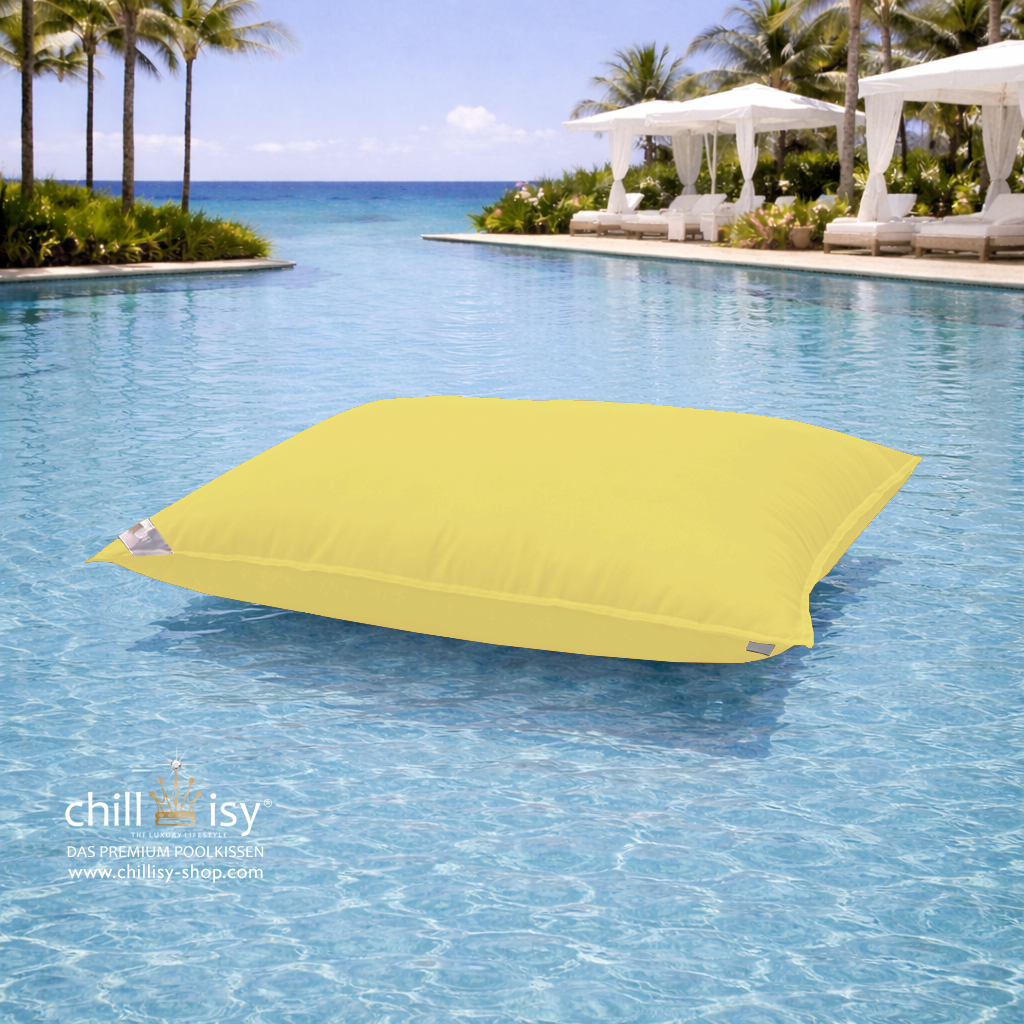 Premium Poolkissen Maxi 190x130 cm von chillisy in Limone Gelb im Pool mit Meeranschluss treibend.